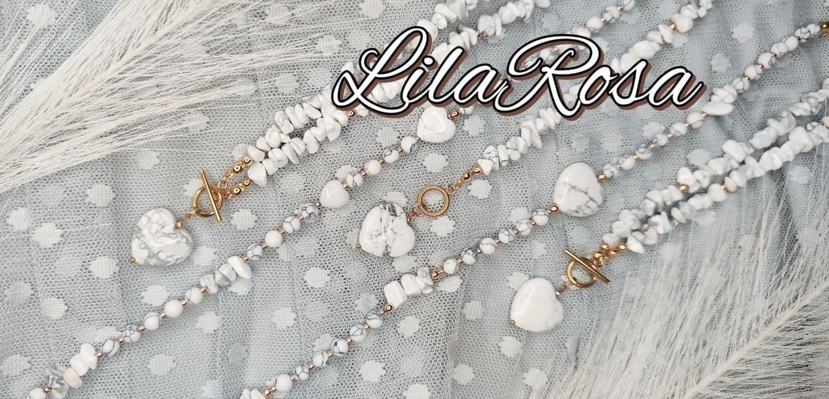 LlaRosa brand display of white and pearl beaded bracelets and necklaces arranged on textured gray fabric with faux fur